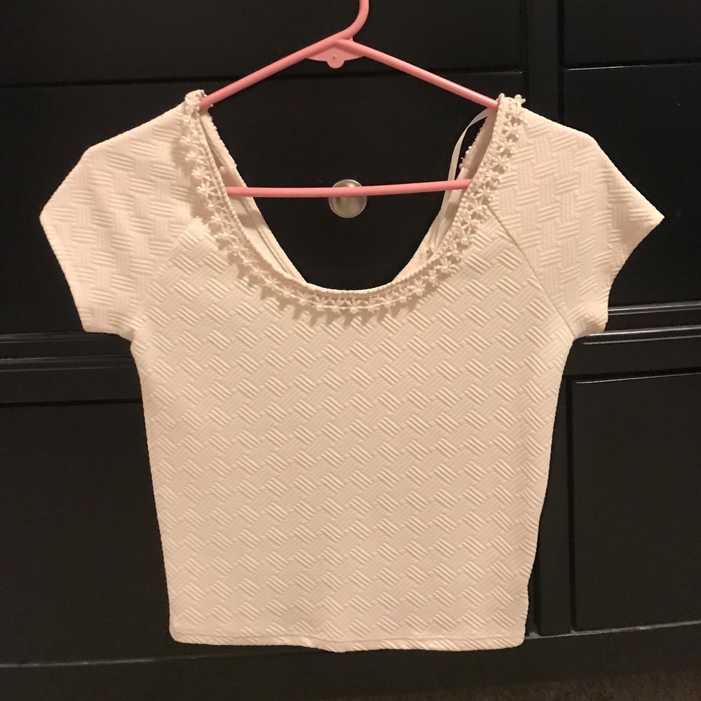 Cream cropped top. With a pearl neckline.